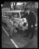 Richard D. Hopa and Hiroshi Kimura demonstrating anti-smog device for automobiles in Los Angeles, Calif., 1960