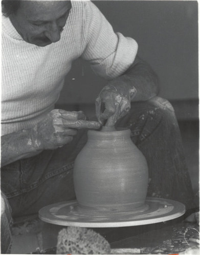Paul Soldner with pottery wheel, Scripps College