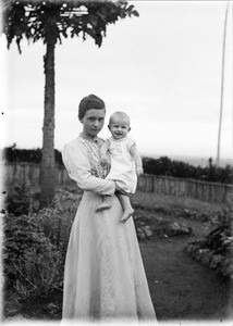 Missionary Elisabeth Müller with baby in the garden, Tanzania, ca.1893-1920