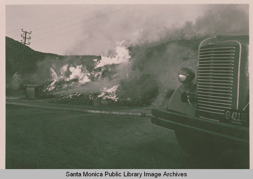 Flames on Pacific Coast Highway with a fire engine in the foreground