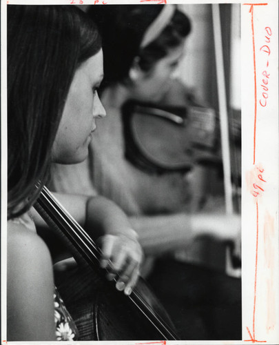 Two women practice music together, Scripps College