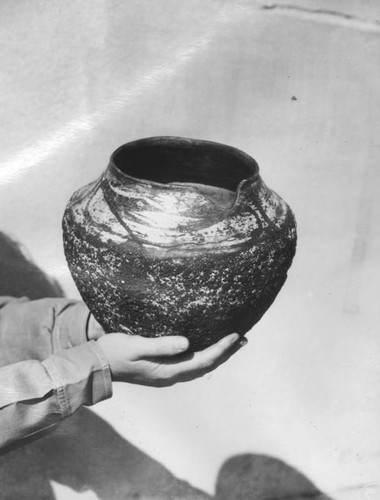 Holding a Native American ceramic pot