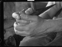[Hands with pipe. Unidentified person.] [negative]