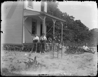 Laberdag middag. 22 Juli 1911. [Men by garden in front of house.] [negative]