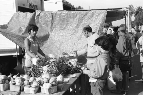 Vendor selling produce at a farmers' market in Inglewood, Los Angeles, 1985