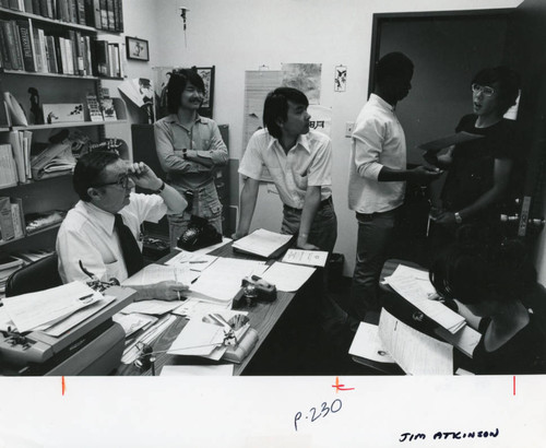 Jim Atkinson in his office with students, 1976