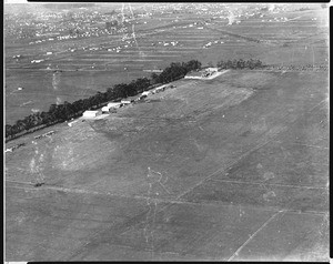 Aerial view of Clover Field Airport in Santa Monica, showing residences in the distance, ca.1924