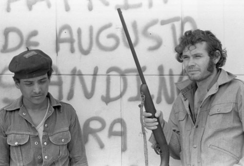 Sandinistas in front of graffiti, Nicaragua, 1979