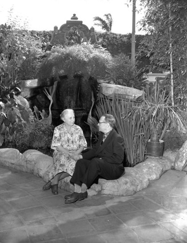 Allis and DeWitt Hutchings by pond, Mission Inn