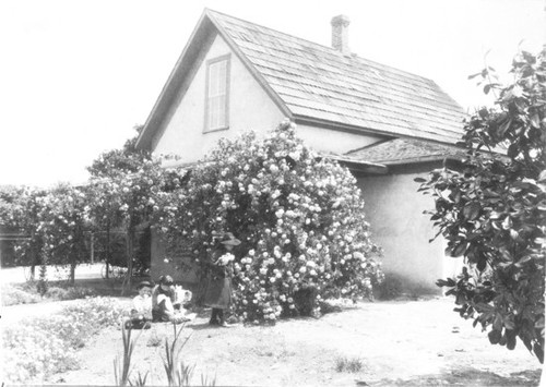 Woman and children in garden, D. H. Burnham home