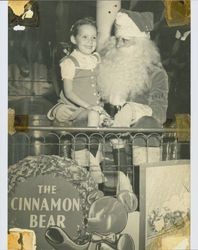 Little girl sitting on Santa's lap at Tomasini Hardware Company, Petaluma, California, about 1946