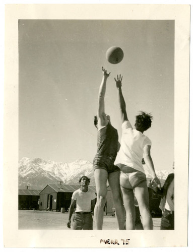 Photograph of tip off for a boys basketball game at Manzanar