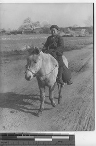 A boy rides a Manchurian pony at Fushun, China, 1936