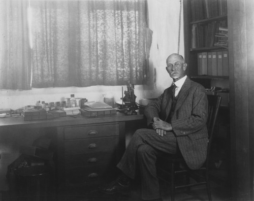 Thomas Wayland Vaughan (1870-1952), shown here in his laboratory at Scripps Institution of Oceanography. He was a geologist, paleontologist, and oceanographer. He also served as the director of Scripps Institution of Oceanography from 1924-1936. Circa 1929
