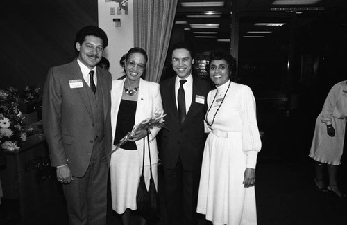 Paul C. Hudson posing with Rosa Hill and others at a Broadway Federal Savings and Loan event, Los Angeles, 1984