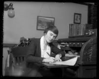Margaret Bullen, superintendent of Los Angeles' Juvenile Hall, at her desk writing, 1921