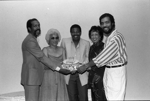 Ndugu Chancler and others holding a birthday cake at the Pied Piper Nightclub, Los Angeles, 1985