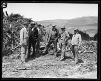 Six geologists and/or civil engineers standing in front of flood debris following the flood resulting from the failure of the Saint Francis Dam, San Francisquito Canyon (Calif.), 1928