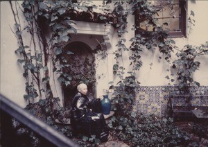 Marta Feuchtwanger sitting in the garden of her Pacific Palisades home, ca. 1970-1980