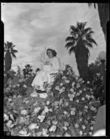 Shirley Temple, Grand Marshall, rides her float on a throne of roses at the Tournament of Roses Parade, Pasadena, 1939