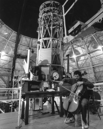 Geoffrey W. Marcy playing the cello in the 100-inch telescope observatory, Mount Wilson Observatory