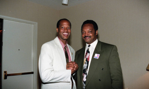 Rev. Jesse Jackson posing with an unidentified man at a Tournament of roses protest rally, Pasadena, 1993