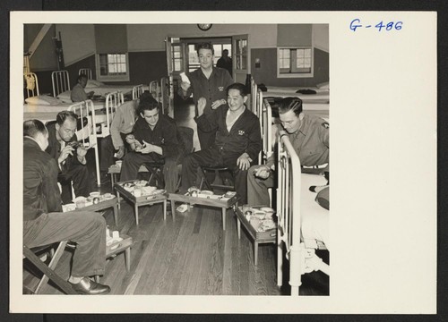 Sgt. Isamu Sanemitsu with his fellow patients takes his mess in the ward at Moore General Hospital, Swannanoa, North Carolina
