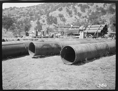 A construction crew unloading pipe for the construction of Tule Plant