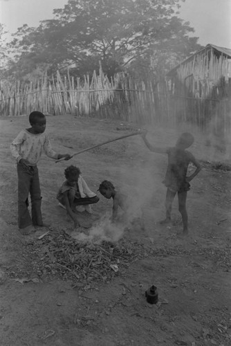 Children playing with a small fire in the street, San Basilio de Palenque, ca. 1978