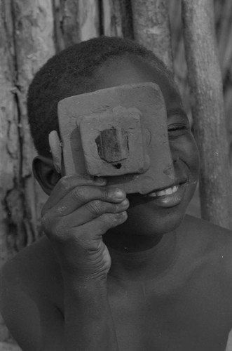 Boy playing with a toy camera, San Basilio de Palenque, 1977