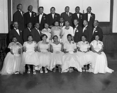 Group photograph of men and women in formal attire