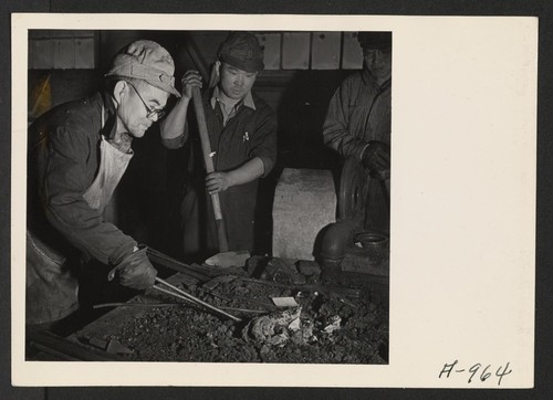 Evacuee blacksmiths do all the blacksmith work necessary in the garage, at this relocation center. Photographer: Stewart, Francis Newell, California