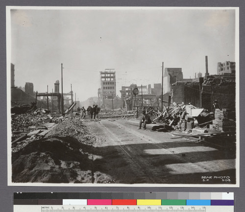 [View of ruins and rubble, looking north along Kearny St. Telegraph Hill in distance.]