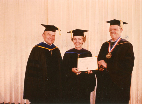 M. Norvel Young, Nancy Reagan, and Howard White in academic regalia, 1983