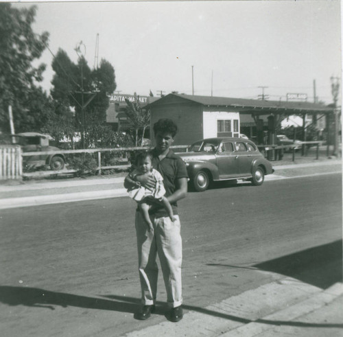 Ted Lechuga holding his niece, East Los Angeles, California