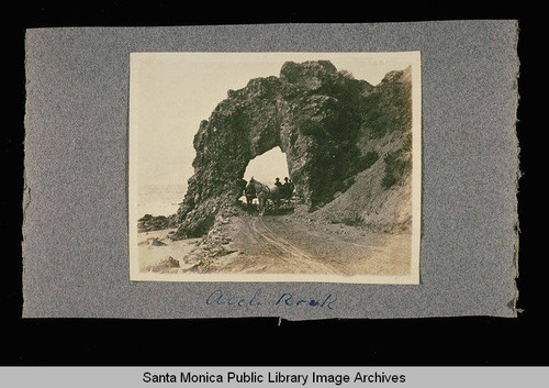 Horse and buggy in front of Arch Rock on the coast road just south of Topanga Canyon, Calif
