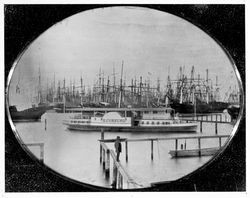 Charles Minturn standing in front of the paddle steamer E. Corning, San Francisco, California, about 1852