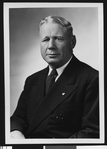 University of Southern California assistant football coach Roy "Bullet" Baker, studio shot, solid dark tie, dark jacket, 1948