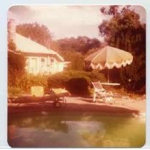 Photographs of Bolinas Bay. Built-in swimming pool, patio furniture behind a house