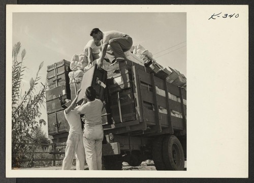Baggage of residents leaving from the Parker, Arizona, Railroad Station is picked up on the morning of their departure by