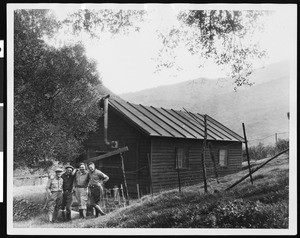 Men posing in front of a mountain cabin ca.1930