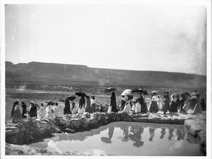 Procession of women next to the reservoir during the Fiesta de San Esteban (Saint Stephen), Acoma Pueblo, New Mexico, 1896