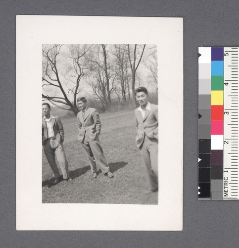 Groups of men #10 [three standing; trees in bkgrd.]