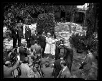Reporters surrounding actors Tyrone Power and Annabella after their wedding ceremony in Bel-Air, Calif., 1939