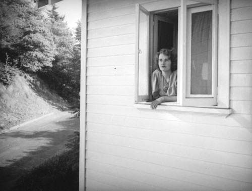 Ethel Schultheis looking out her home window
