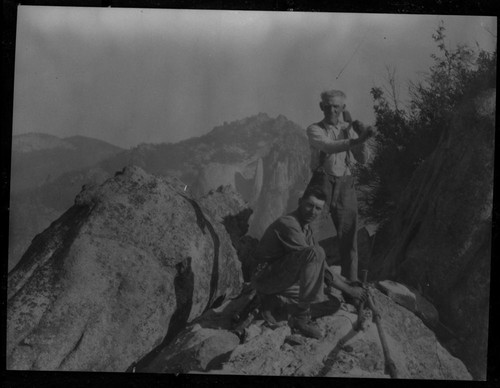 Construction, Geo Swanson striking, Armin Grunnigin holding, building wooden steps up Moro Rock in 1917. Cross-file NPS Individuals