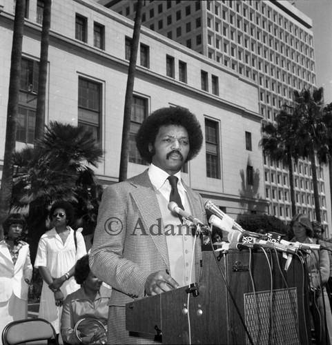 Jesse Jackson at news microphones, Los Angeles, 1977