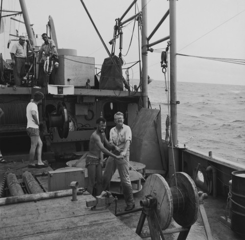 John Isaacs (right) belaying line into a winch, off the stern of R/V Spencer F. Baird