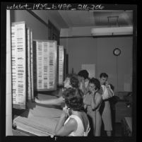 Five city hall receptionists taking telephone reservations for municipal golf courses tee times in Los Angeles, Calif., 1962