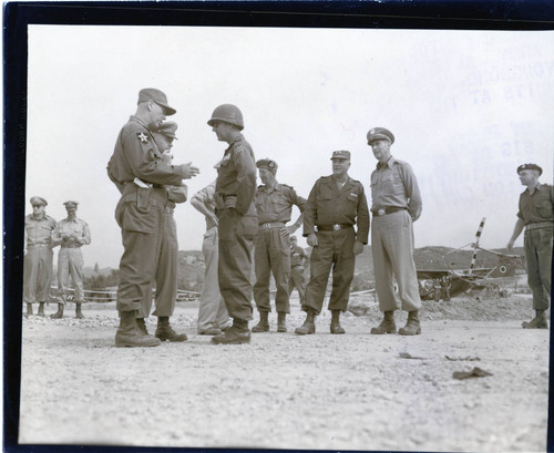 General J. Lawton Collins and others waiting during tour